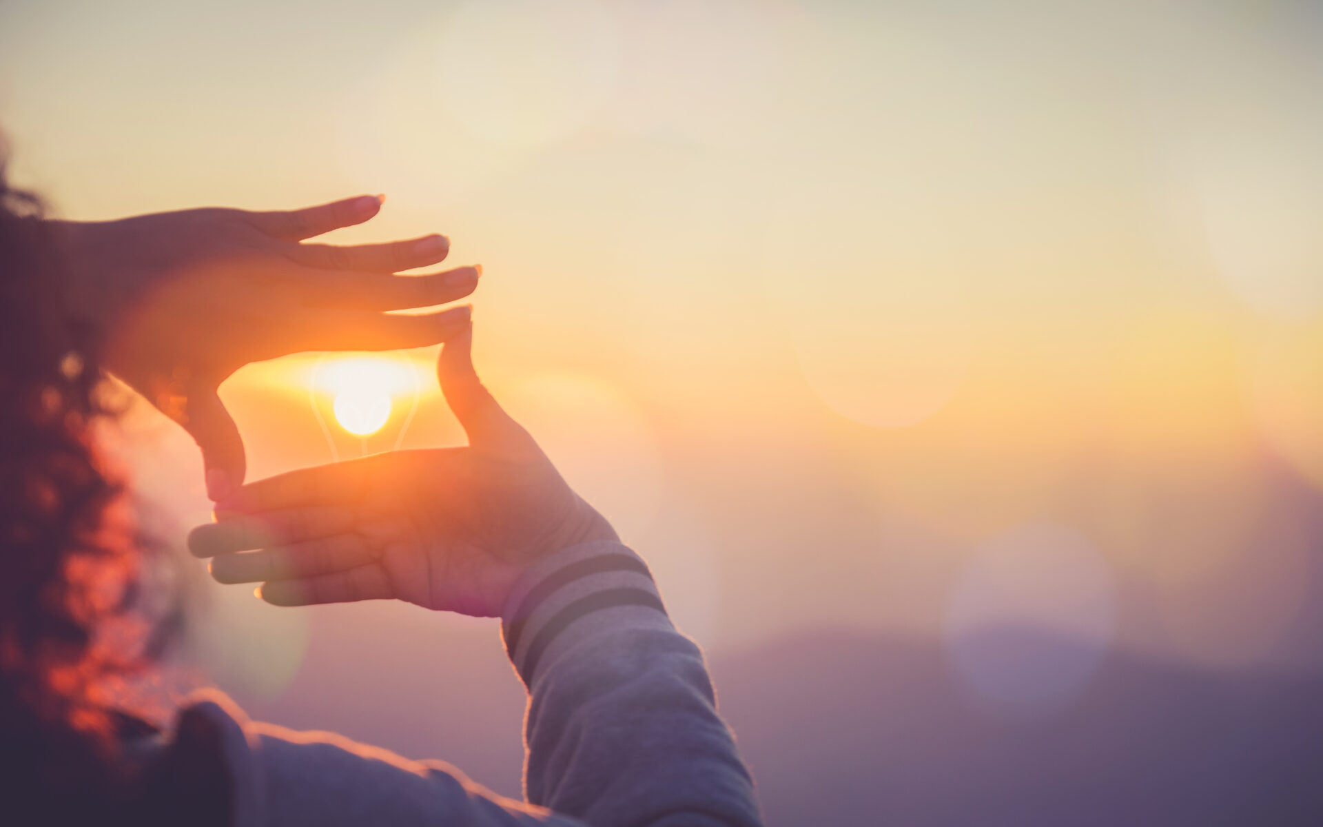 The woman making frame round the sun with her hands in sunrise,Future planning idea concept.